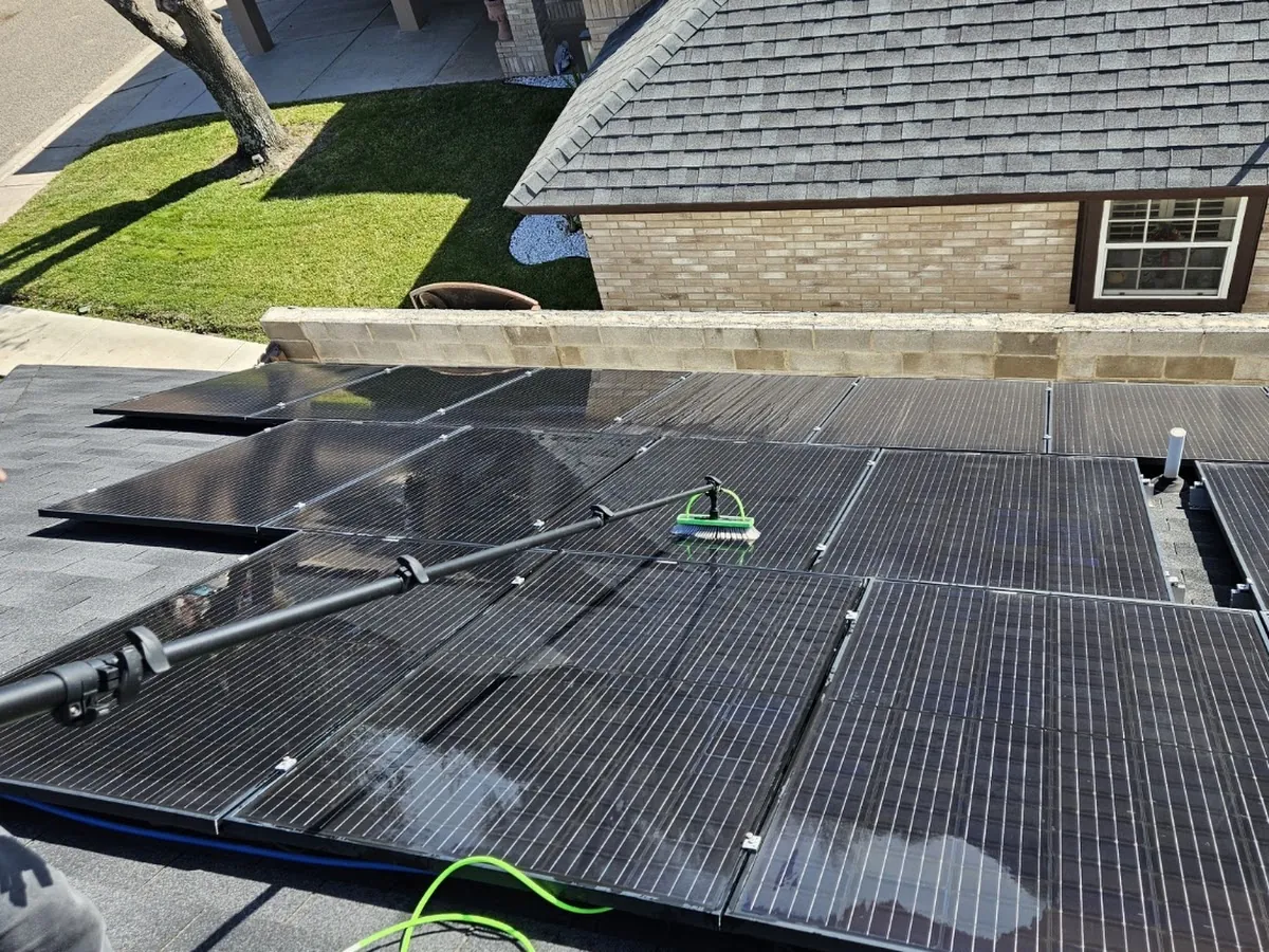 Otto's technician washing a large residential solar array in Laredo