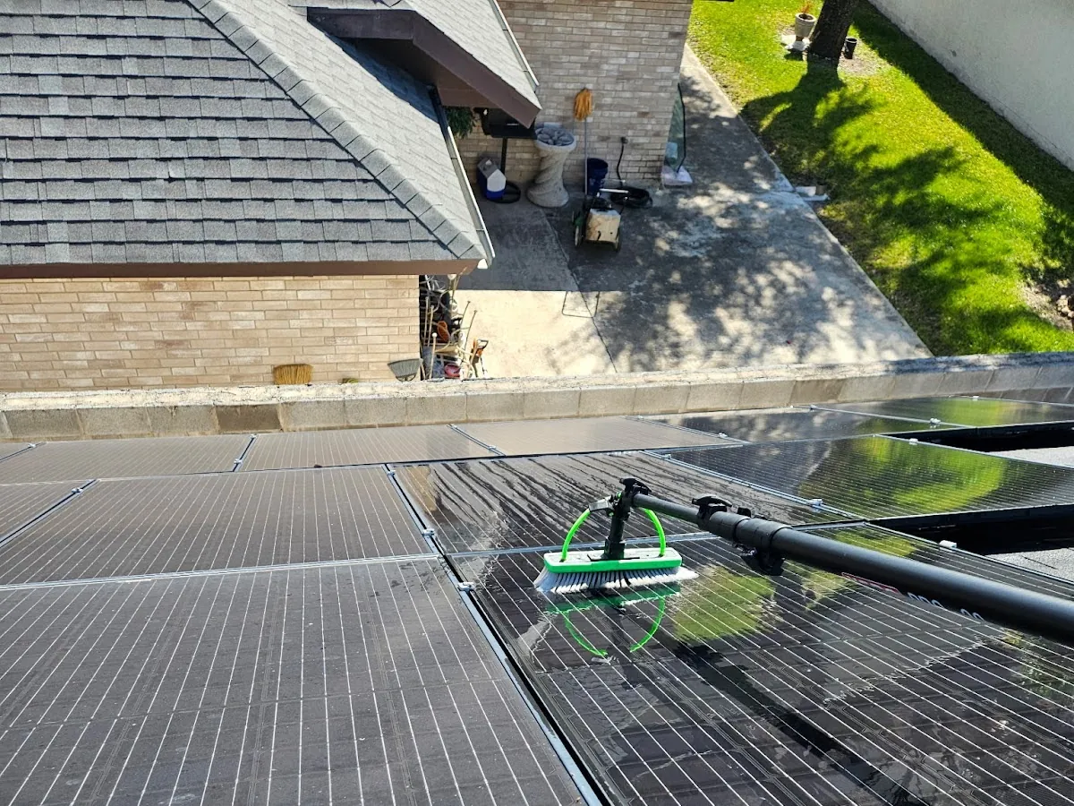 Otto's technician rinsing solar panels on a residential roof in Laredo